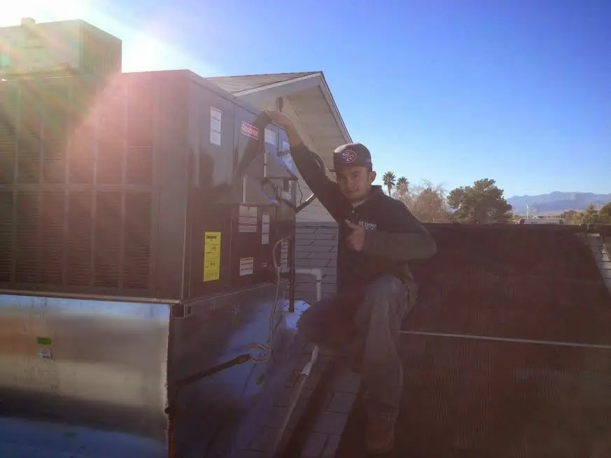 HVAC technician performing HVAC Inspection on a rooftop unit in Baldwin Park